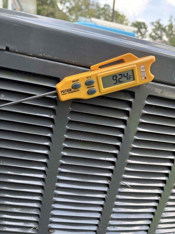 # CP-Cooling Problem

Responded to no-cooling complaint on 6-year-old Trane air conditioning system. Upon inspection, found condenser unit with severely restricted airflow due to heavy accumulation of dirt, debris, and lint completely covering exterior condenser coil surfaces. Outdoor ambient temperature measured at 92°F. Condenser coil buildup was extensive and matted, significantly reducing heat transfer capacity and system efficiency. Documented unit condition with photographs showing compromised coil surfaces and overall neglect of routine maintenance. System components were operational but unable to achieve adequate cooling due to restricted condenser coil preventing proper heat rejection. Recommended thorough condenser coil cleaning to restore proper airflow and system performance.