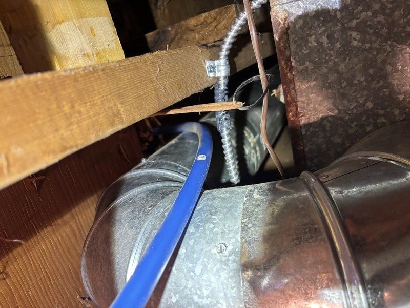 Responded to third service call for air conditioning system running continuously, requiring thermostat setting of 76°F to cycle off. Upon inspection, discovered significant disconnected ductwork in attic space, which was causing substantial conditioned air loss and preventing proper system cycling. Documented ductwork separation with photos showing metal duct connections pulled apart from mounting brackets and structural supports. Addressed customer concerns regarding previous capacitor diagnosis, confirming that disconnected ductwork was the primary issue affecting system performance rather than electrical components. Explained how air loss from separated ducts created continuous cooling demand, preventing thermostat satisfaction at normal temperature settings.