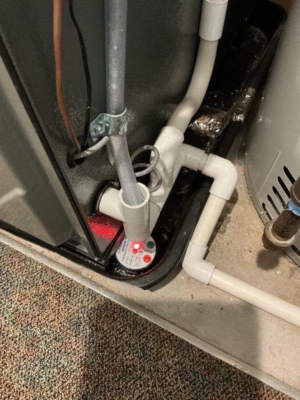 # NC-No Cool Service Completed

Responded to no cooling call with no air flow from vents. Upon inspection, found HVAC system pressure switches indicating fault condition. Identified condensate drainage issue with visible water accumulation on drain line and components. Cleared condensate line blockage causing safety switch activation and system shutdown. Verified pressure switch operation and proper drainage flow. Tested system startup and confirmed normal air flow restored through all vents. Unit returned to normal cooling operation with proper airflow and safety controls functioning as designed.