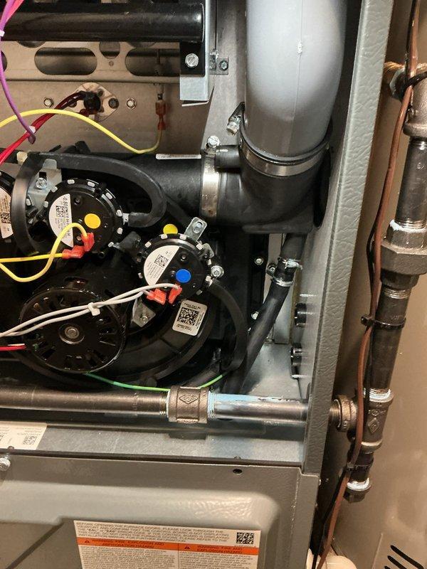 # NC-No Cool Service Completed

Responded to no cooling call with no air flow from vents. Upon inspection, found HVAC system pressure switches indicating fault condition. Identified condensate drainage issue with visible water accumulation on drain line and components. Cleared condensate line blockage causing safety switch activation and system shutdown. Verified pressure switch operation and proper drainage flow. Tested system startup and confirmed normal air flow restored through all vents. Unit returned to normal cooling operation with proper airflow and safety controls functioning as designed.