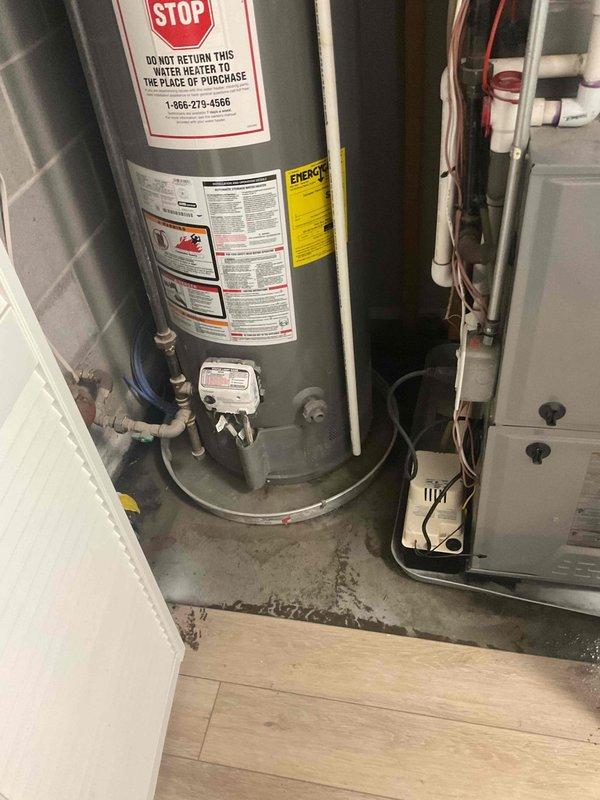 Responded to sewage backup alarm in basement utility area. Upon inspection, documented water heater and HVAC equipment location, noting moisture staining on concrete floor beneath and around water heater base. Assessed plumbing connections, including copper piping and valve controls at water heater base. Photographed affected area and exterior access points for documentation purposes. System evaluated and customer advised of findings.