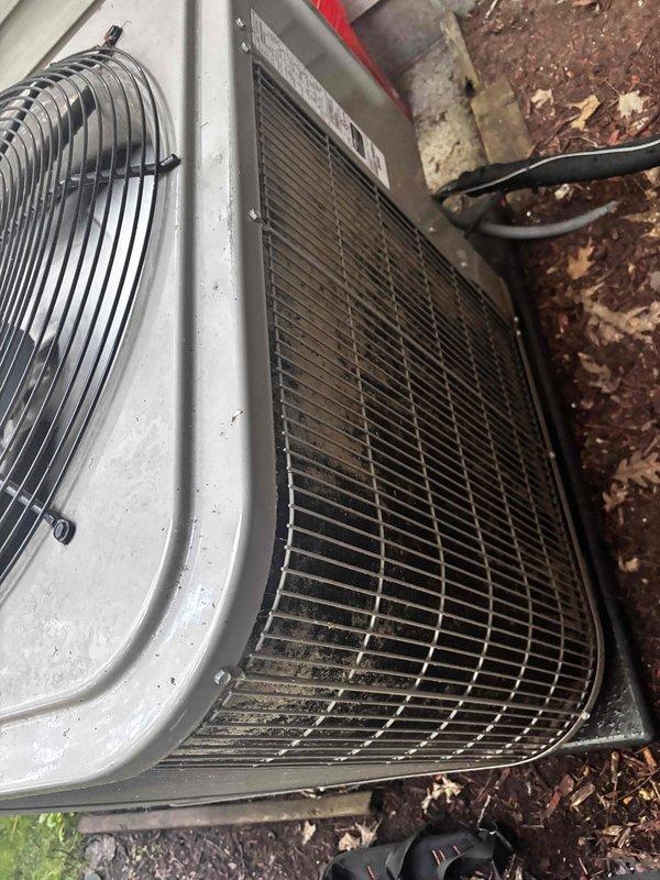 Completed annual cooling maintenance on 9-year-old Bryant air conditioning system. Performed comprehensive tune-up including inspection of outdoor condenser unit, verified proper operation of fan assembly and protective grilles, examined condenser coil fins for damage or debris accumulation, and assessed refrigerant line connections. Documented equipment condition with photographs showing unit positioned on concrete pad with adequate clearance from building structure. System operating within normal parameters upon completion of preventive maintenance service.