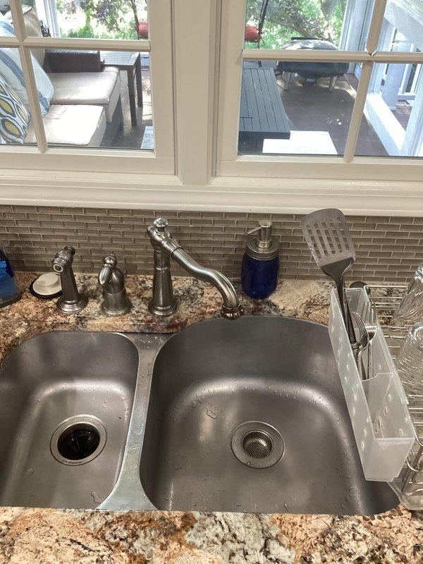 # Plumbing Service Completed

Responded to service call for leaking outdoor spigots. Upon arrival, conducted comprehensive inspection of exterior hose bibs and water supply connections. Documented existing conditions of indoor plumbing fixtures including kitchen and bathroom installations to assess potential related issues affecting outdoor spigot performance.

Inspected kitchen double-basin sink with chrome single-handle faucet and verified proper operation and seal integrity. Examined bathroom vanity with widespread three-piece faucet assembly in oil-rubbed bronze finish to check for any supply line issues that could impact outdoor connections. Photographed all relevant fixtures and connections for service documentation and future reference.

Assessed outdoor spigot leak sources and determined appropriate repair solutions. Work completed to restore proper function and eliminate water waste from exterior faucet connections.