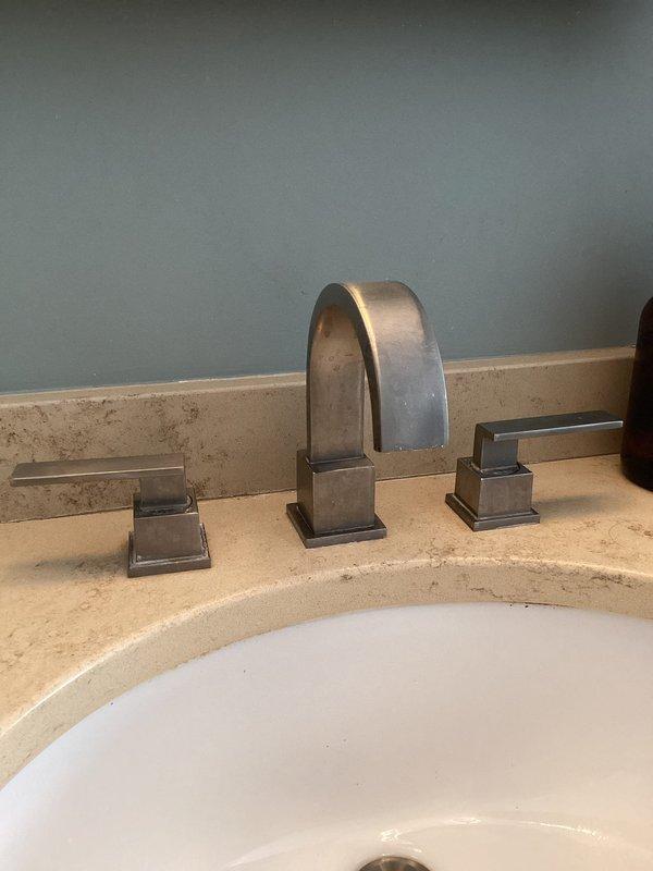 # Plumbing Service Completed

Responded to service call for leaking outdoor spigots. Upon arrival, conducted comprehensive inspection of exterior hose bibs and water supply connections. Documented existing conditions of indoor plumbing fixtures including kitchen and bathroom installations to assess potential related issues affecting outdoor spigot performance.

Inspected kitchen double-basin sink with chrome single-handle faucet and verified proper operation and seal integrity. Examined bathroom vanity with widespread three-piece faucet assembly in oil-rubbed bronze finish to check for any supply line issues that could impact outdoor connections. Photographed all relevant fixtures and connections for service documentation and future reference.

Assessed outdoor spigot leak sources and determined appropriate repair solutions. Work completed to restore proper function and eliminate water waste from exterior faucet connections.