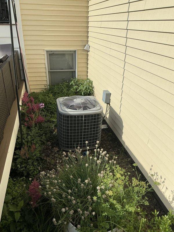 Responded to service call for 16-year-old residential air conditioning system blowing lukewarm air with inadequate cooling performance. Conducted comprehensive system evaluation including inspection of outdoor condenser unit and indoor air handler components in utility room. Documented existing equipment configuration and mechanical space layout showing HVAC ductwork, humidifier accessory, and associated plumbing connections. Prepared estimate for necessary repairs to restore proper cooling function to the system.