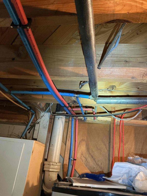 Conducted water quality assessment and site evaluation for potential water filtration system installation. Documented existing plumbing infrastructure in basement utility area, including PEX hot and cold water supply lines, routing configurations, and available installation points for filtration equipment. Trip charge waived per management approval, with client considering supply of their own filtration system for professional installation.