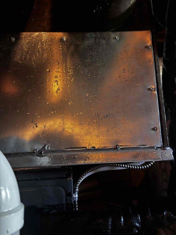 Responded to no heating or cooling call on EnergiAir system (2021 model, warranty through March 2028). Upon inspection, discovered significant condensation accumulation on equipment panels and internal components, indicating moisture-related issues affecting system operation. Documented excessive water droplets on metal surfaces and condensation on glass panels, along with grease and debris buildup on interior components. System evaluated and findings photographed for warranty documentation purposes.
