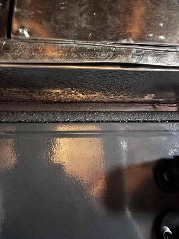 Responded to no heating or cooling call on EnergiAir system (2021 model, warranty through March 2028). Upon inspection, discovered significant condensation accumulation on equipment panels and internal components, indicating moisture-related issues affecting system operation. Documented excessive water droplets on metal surfaces and condensation on glass panels, along with grease and debris buildup on interior components. System evaluated and findings photographed for warranty documentation purposes.
