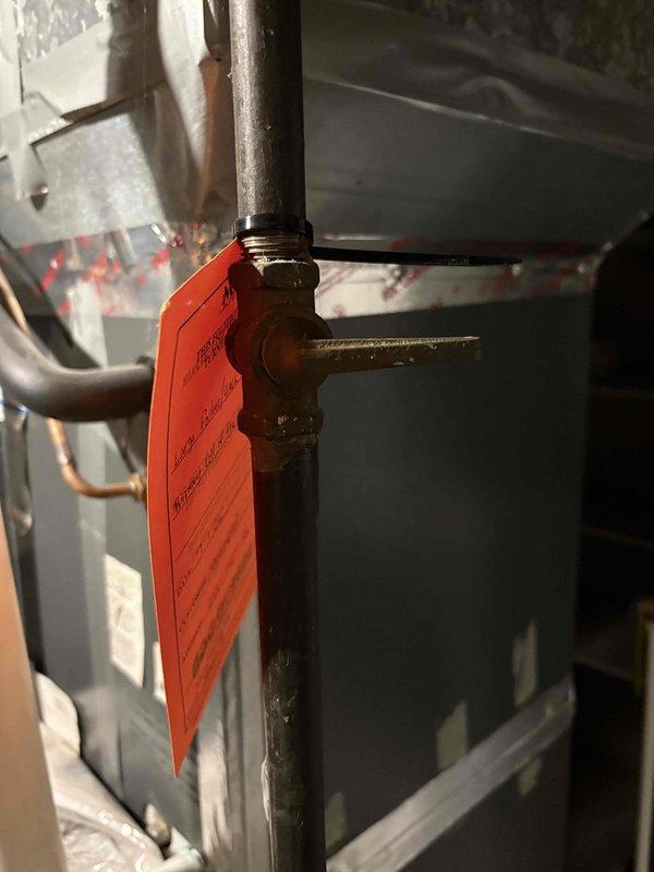 Completed pre-purchase HVAC inspection at vacant property. Upon examination of heating system, discovered extensive rust and corrosion on equipment base and mounting surfaces, indicating prolonged moisture exposure and water damage. System components showed significant deterioration with heavy oxidation on metal surfaces and mineral deposits present. Tagged equipment and documented conditions with photographs for buyer's review.