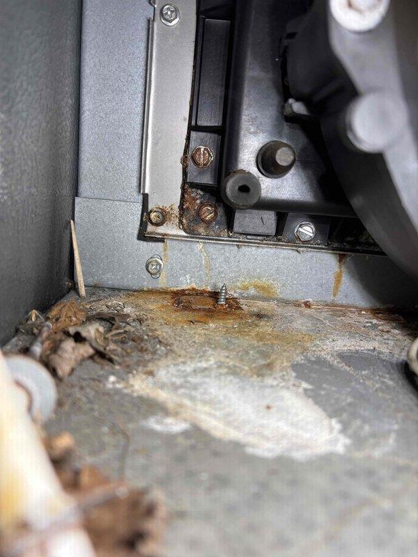 Completed pre-purchase HVAC inspection at vacant property. Upon examination of heating system, discovered extensive rust and corrosion on equipment base and mounting surfaces, indicating prolonged moisture exposure and water damage. System components showed significant deterioration with heavy oxidation on metal surfaces and mineral deposits present. Tagged equipment and documented conditions with photographs for buyer's review.