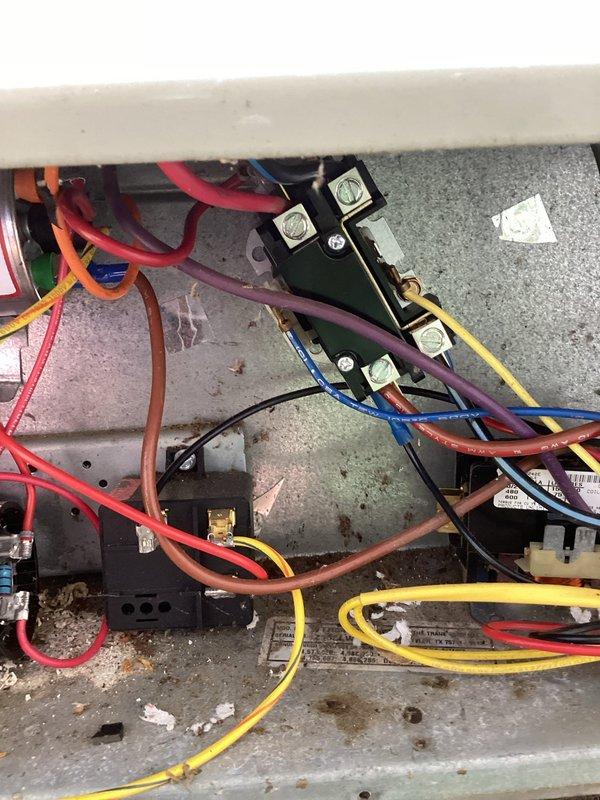 Completed annual cooling maintenance on three 24-year-old Trane air conditioning systems. Performed comprehensive tune-up procedures including inspection of electrical connections, capacitors, and control wiring within junction panels. All units showed age-appropriate wear with minor debris accumulation in outdoor housings. Verified proper electrical connections at terminal blocks, inspected capacitor conditions, and confirmed motor components operational. Documented equipment condition with photos showing interior electrical configurations and outdoor unit housings with typical weathering for equipment age.