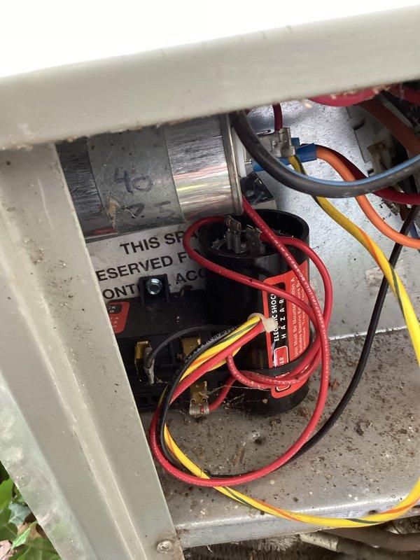 Completed annual cooling maintenance on three 24-year-old Trane air conditioning systems. Performed comprehensive tune-up procedures including inspection of electrical connections, capacitors, and control wiring within junction panels. All units showed age-appropriate wear with minor debris accumulation in outdoor housings. Verified proper electrical connections at terminal blocks, inspected capacitor conditions, and confirmed motor components operational. Documented equipment condition with photos showing interior electrical configurations and outdoor unit housings with typical weathering for equipment age.