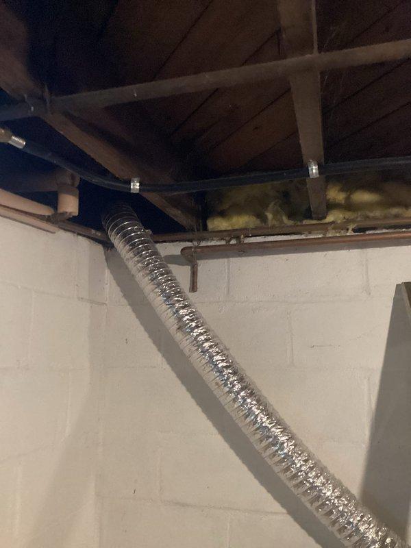Provided comprehensive plumbing project estimate for bathroom installation in 75-year-old residence. Conducted thorough site assessment of existing infrastructure, including inspection of basement plumbing systems, copper supply lines with characteristic U-bend configurations, exposed wooden floor joists, and HVAC ductwork routing. Documented current conditions of concrete block foundation walls, existing pipe penetrations, and structural elements to determine scope of work required for new bathroom installation in aging home with vintage plumbing systems.