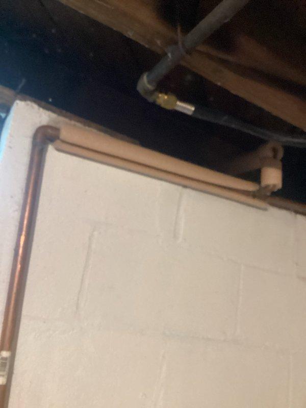 Provided comprehensive plumbing project estimate for bathroom installation in 75-year-old residence. Conducted thorough site assessment of existing infrastructure, including inspection of basement plumbing systems, copper supply lines with characteristic U-bend configurations, exposed wooden floor joists, and HVAC ductwork routing. Documented current conditions of concrete block foundation walls, existing pipe penetrations, and structural elements to determine scope of work required for new bathroom installation in aging home with vintage plumbing systems.