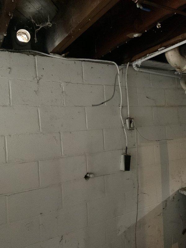 Completed on-site assessment for installation of 15-foot gas line run to accommodate dryer hookup in 1948-built home with no existing gas line infrastructure. Evaluated unfinished basement area with exposed floor joists, concrete block foundation walls, and existing utility systems including PVC plumbing, ductwork, and electrical conduit to determine optimal routing path for new gas line installation. Documented current conditions and structural layout to provide accurate material requirements and labor estimate for proposed gas line extension project.