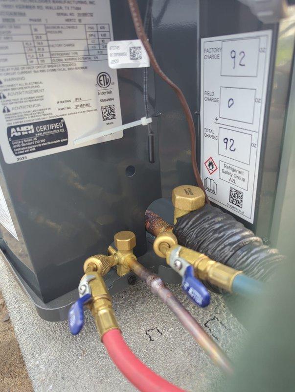 Successfully completed full air conditioning system replacement. Removed existing unit and installed new residential condenser on concrete pad against exterior wall. Connected refrigerant lines to unit via brass service valves with proper line set installation. Verified factory charge specifications and completed system charging procedures. Performed leak testing and system startup to ensure proper operation of new equipment.
