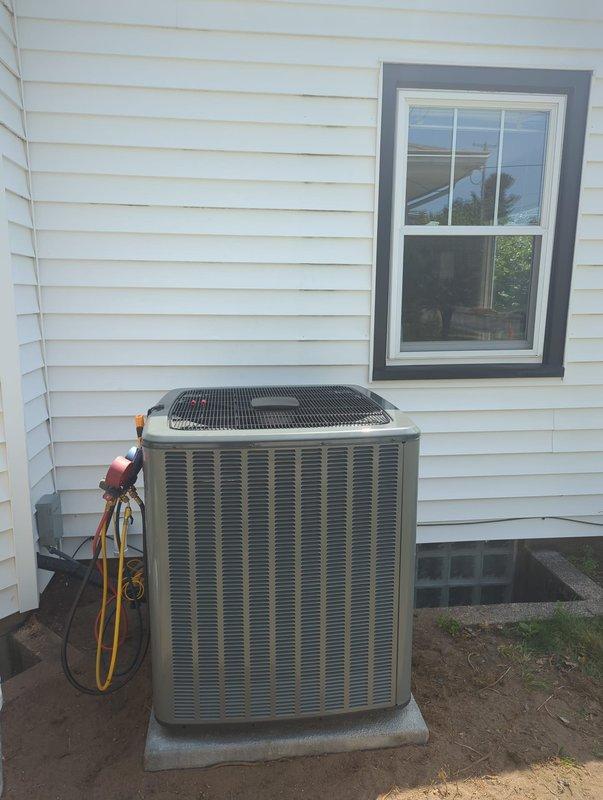 Successfully completed full air conditioning system replacement. Removed existing unit and installed new residential condenser on concrete pad against exterior wall. Connected refrigerant lines to unit via brass service valves with proper line set installation. Verified factory charge specifications and completed system charging procedures. Performed leak testing and system startup to ensure proper operation of new equipment.