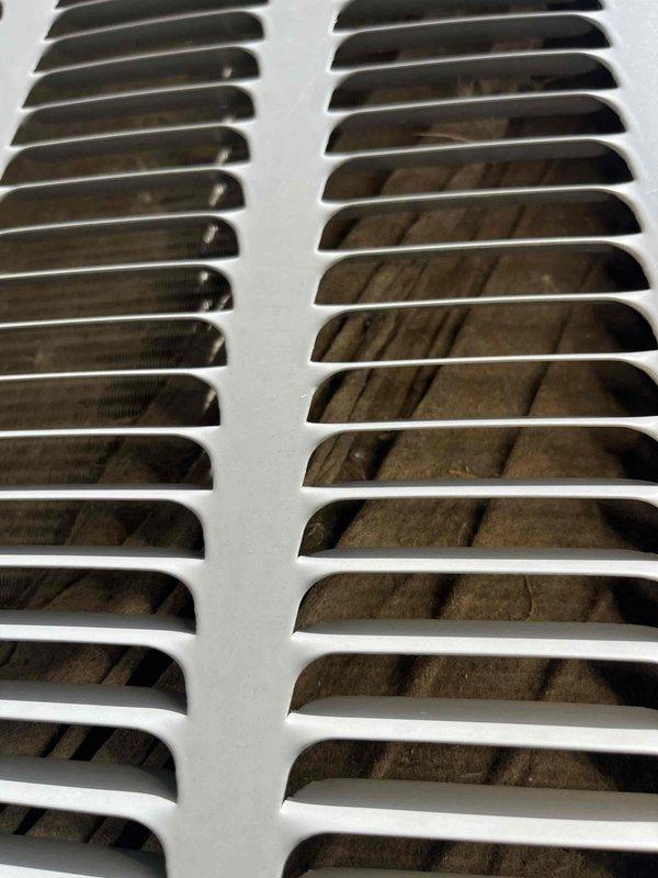 Responded to HVAC system concern and performed initial diagnostic assessment. Upon inspection, found significant dust and debris accumulation behind ventilation grilles, indicating poor air quality and potential airflow restriction. Documented current conditions with photographs showing substantial particulate buildup on return air registers. Technician will return with necessary equipment to complete further diagnosis and address ventilation system issues. Customer contacted and work order remains open pending completion of diagnostic procedures.