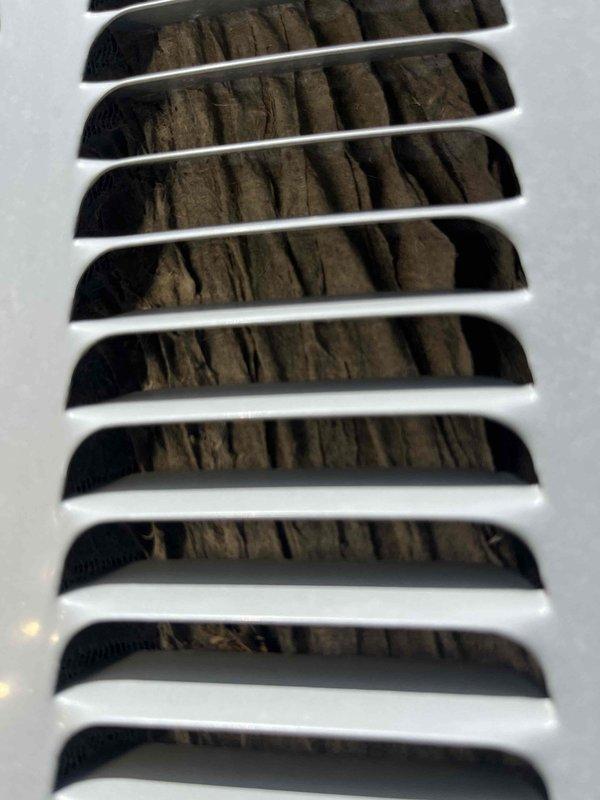 Responded to HVAC system concern and performed initial diagnostic assessment. Upon inspection, found significant dust and debris accumulation behind ventilation grilles, indicating poor air quality and potential airflow restriction. Documented current conditions with photographs showing substantial particulate buildup on return air registers. Technician will return with necessary equipment to complete further diagnosis and address ventilation system issues. Customer contacted and work order remains open pending completion of diagnostic procedures.