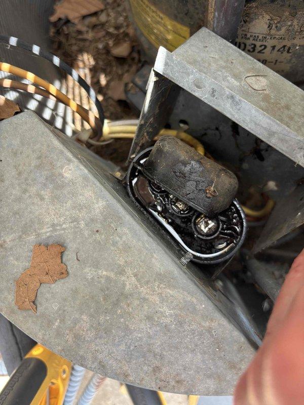 # Cooling System Diagnostic and Repair

Responded to service call for inadequate cooling performance on downstairs 31-year-old Trane split system with condenser manufactured in 2014. Upon arrival, performed comprehensive system evaluation including visual inspection of both indoor air handler and outdoor condensing unit.

Conducted thorough examination of outdoor unit components, identifying signs of extended service life with accumulated dust, dirt, and minor surface corrosion on metal housing and mounting brackets. Inspected electrical connections, capacitor housing, and motor components for proper operation and physical condition. Noted environmental factors including installation in enclosed mechanical space with evidence of age-related wear on equipment surfaces.

Examined outdoor condensing unit electrical control box, observing weathering and rust staining on housing exterior consistent with extended outdoor exposure. Verified integrity of electrical connections and wiring, incl