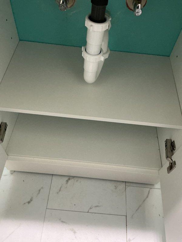 Completed installation and testing of bathroom sink plumbing system, including PVC drain assembly and brushed stainless steel single-lever faucet. Verified proper water flow, drainage function, and confirmed no leaks in cabinet connections beneath vessel sink.