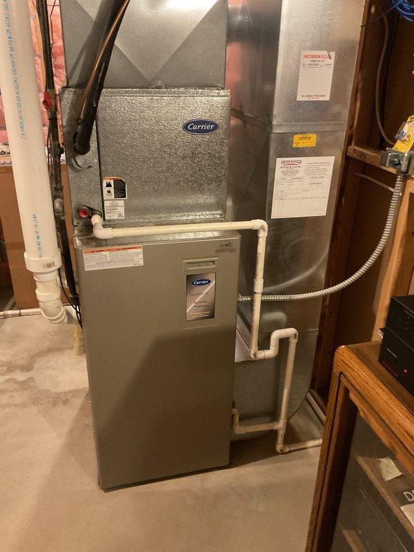 # NC-No Cool Service Completed

Responded to service call for 19-year-old Carrier system with complete loss of cooling affecting entire home. Upon arrival, performed comprehensive system diagnostics on both indoor air handler and outdoor condensing unit. Inspected electrical connections, refrigerant lines, and control circuits throughout the system.

Evaluated the air handler unit mounted in basement utility area, verifying proper power supply and control board functionality. Checked evaporator coil accessibility and condensate drainage system including PVC drain lines. Inspected furnace component integration with cooling system to ensure proper blower operation and airflow.

Examined copper refrigerant line sets with insulation sleeves for signs of leaks, damage, or deterioration. Verified all mechanical connections between indoor and outdoor units were secure and properly sealed. Assessed overall system age and condition, noting the equipment has been in service for 19 years.

Docume