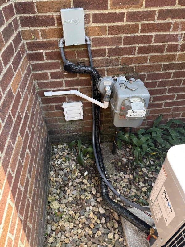 Completed full air conditioning system replacement at residential property. Removed existing unit and installed new Carrier condenser in exterior brick alcove with proper clearance for airflow and serviceability. Mounted unit on concrete pad with river rock drainage bed for water management. Installed associated electrical components including disconnect box, conduit runs, and proper wiring connections per manufacturer specifications and local code requirements. Verified refrigerant lines, condensate drainage, and all electrical connections. System tested and confirmed operational with proper cooling performance.