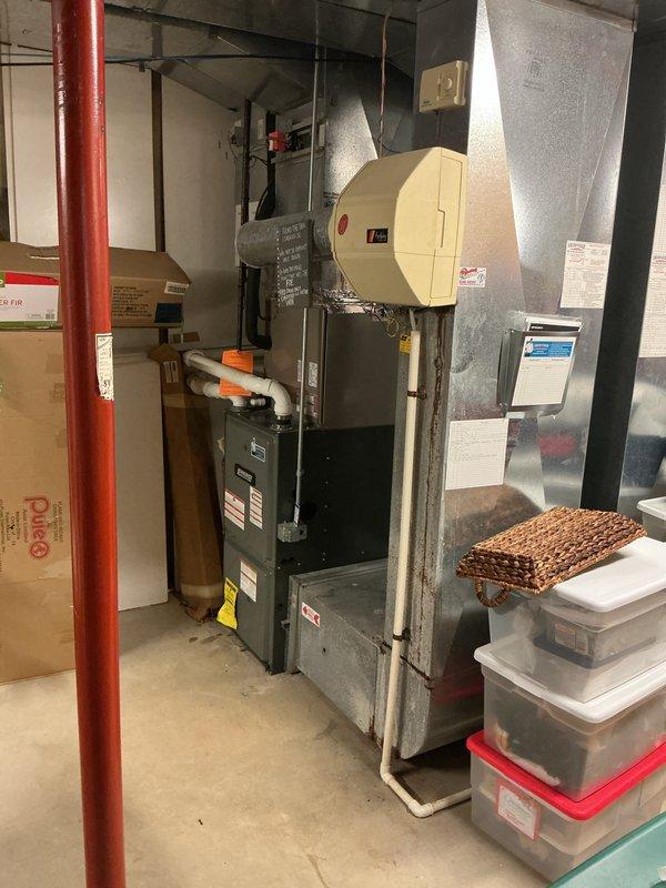 Responded to no-cool complaint on upstairs air conditioning unit affecting entire home. Accessed equipment through service door to garage with no one home. Inspected 5-year-old EnergiAir system located in basement utility area alongside furnace and ductwork. Documented equipment condition with photos showing HVAC system, ductwork connections, and surrounding mechanical room. Diagnosed issue with smaller capacity unit responsible for cooling upper level of residence. Completed necessary repairs to restore cooling function and verified system operation. Provided wrap-up call to homeowner as requested to confirm service completion and system restoration.