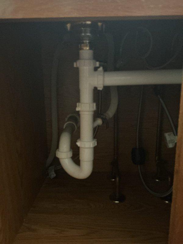 Completed installation of client-supplied double-basin stainless steel kitchen sink with bronze finish single-handle faucet. Connected all drain assemblies including P-trap configuration and verified proper water supply connections and drainage function.