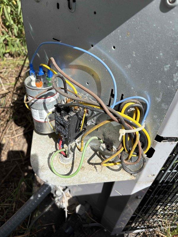 Responded to no cooling complaint on residential HVAC system. Upon arrival, confirmed outdoor condensing unit was not operating while indoor air handler was circulating air through vents. Inspected outdoor unit and found failed dual run capacitor preventing compressor and condenser fan motor from starting. Capacitor showed visible signs of deterioration and tested out of specification. Replaced defective capacitor with proper OEM replacement rated for system requirements. Verified all electrical connections were secure at contactor and capacitor terminals. Cycled system through complete cooling operation and confirmed compressor and condenser fan motor both energized properly. System now cooling effectively with normal temperature split across evaporator coil.
