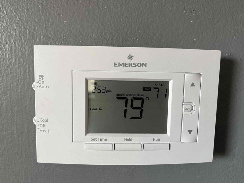 Completed comprehensive ASTU-AC Super Tune-up on residential cooling system. Performed full system inspection including thermostat functionality check (Emerson programmable unit operating at 79°F with 71°F setpoint), verified proper cooling cycle operation, and inspected outdoor condenser unit. Cleaned condenser coil, checked refrigerant lines for proper insulation and connections, verified fan motor operation, and confirmed system is cooling efficiently with no issues identified.