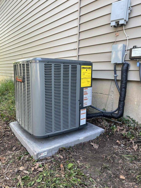 Complete HVAC system replacement performed at residential property. Removed existing air conditioning unit and installed new outdoor condensing unit on concrete pad against exterior wall with proper refrigerant line connections and electrical conduit routing. Indoor air handler unit installed in mechanical closet with new PVC condensate drain lines, proper venting, and electrical connections. All refrigerant lines insulated and secured to building exterior using appropriate mounting hardware. System charged to manufacturer specifications, electrical connections verified at disconnect boxes, and all safety controls tested for proper operation. Unit startup completed with airflow verification and thermostat calibration confirmed.