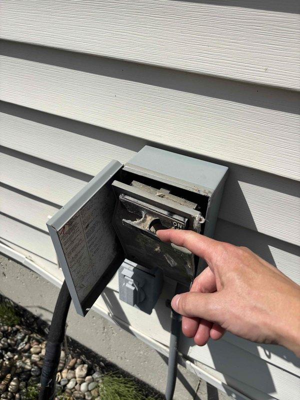 Responded to no-cooling complaint on 18-year-old Carrier air conditioning system. Upon arrival, confirmed unit was blowing warm air and unable to maintain desired temperature. Instructed homeowner to shut off AC and switch thermostat to fan-only mode to prevent further system stress. 

Inspection revealed severely deteriorated indoor evaporator coil with extensive dust and debris accumulation restricting airflow. Ductwork showed signs of long-term neglect with thick particulate buildup on coil surfaces and surrounding components. Observed damaged section in air handler with torn metal and exposed interior, compromising system efficiency. Electrical wiring visible within debris field presented potential safety concerns.

Examined outdoor disconnect box and verified electrical connections. System age and condition of critical components indicate unit is operating beyond typical service life expectancy. Provided homeowner with findings and recommended immediate system evaluation for poten