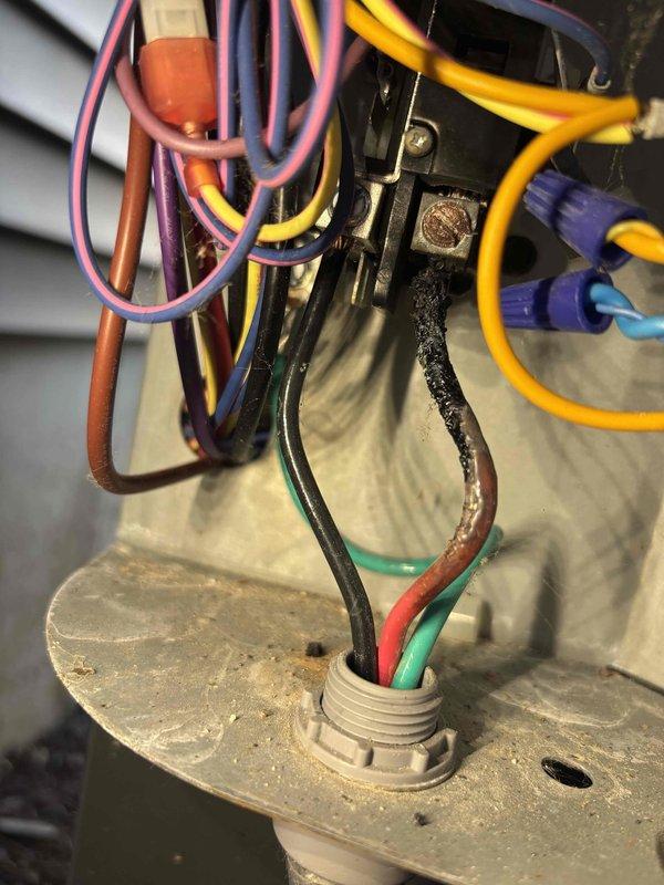 # Cooling System Repair - No Outdoor Unit Operation

Responded to service call for non-operational outdoor condensing unit while indoor furnace fan was running normally. Upon inspection of outdoor unit electrical components, discovered severely damaged wire insulation on low voltage control wiring leading to contactor assembly. Wire showed signs of thermal damage with melted, deteriorated insulation that compromised electrical connectivity and prevented contactor energization.

Replaced damaged control wiring and verified proper electrical connections at contactor terminals. Tested system operation and confirmed outdoor unit now engages properly when thermostat calls for cooling. All electrical connections secured and system returned to normal operation.
