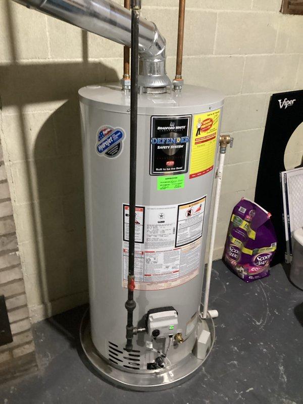Performed on-site evaluation of existing Bradford White water heater, approximately six years old, to provide replacement estimate. Unit currently operational with no reported issues or symptoms. Documented existing installation including all plumbing connections, venting configuration, and utility room layout. Assessed copper and metal piping connections at top of unit, floor drain proximity, and available clearances for potential replacement. Photographed current water heater specifications, energy guide information, and Defender Safety System components to ensure accurate quote preparation for future replacement.