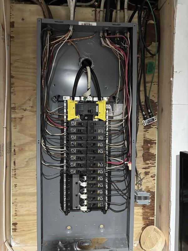 Responded to service call for non-functioning ceiling fan with burning odor. Upon inspection, traced electrical issue to main panel and verified proper circuit breaker operation and connections. Documented electrical panel interior showing circuit breaker array, wire routing, and safety components, as well as exterior meter base and service entrance equipment. Resolved electrical concern and restored safe operation of ceiling fan circuit.