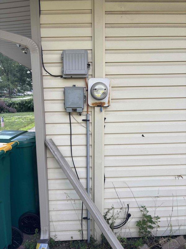 Responded to service call for non-functioning ceiling fan with burning odor. Upon inspection, traced electrical issue to main panel and verified proper circuit breaker operation and connections. Documented electrical panel interior showing circuit breaker array, wire routing, and safety components, as well as exterior meter base and service entrance equipment. Resolved electrical concern and restored safe operation of ceiling fan circuit.