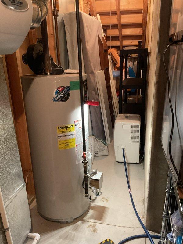 Conducted water heater replacement estimate for a 20-year-old residential unit showing signs of age-related wear. Assessed basement mechanical room conditions, documented existing water heater installation alongside HVAC equipment, and provided replacement recommendations to ensure continued reliable domestic hot water supply.