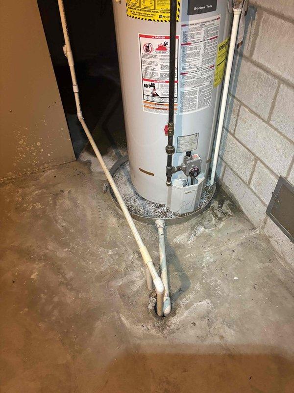 Responded to service call for air conditioning unit that would not turn on and had suspected blower motor failure on 15-20 year old system. Upon arrival, conducted diagnostic assessment of HVAC system and related mechanical equipment in utility room. Documented existing conditions of water heater, plumbing connections, ductwork, and surrounding infrastructure through photographic evidence for service records.