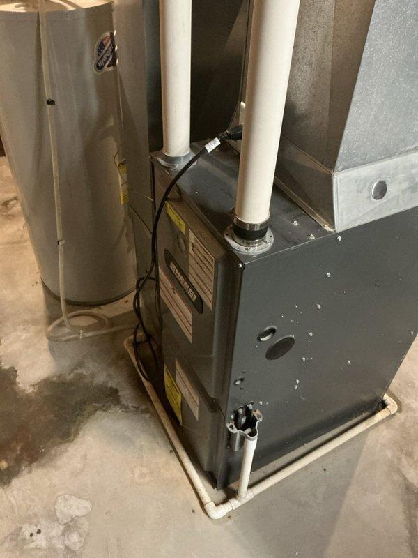 Responded to service call for non-operational air conditioning system. Upon arrival, conducted thorough inspection of residential HVAC installation located in basement mechanical room. System consists of gray metal furnace unit with associated water heater, copper refrigerant lines, and white PVC intake/exhaust venting. Performed diagnostic assessment of equipment to identify cause of cooling failure. Documented existing installation configuration including furnace positioning, ductwork connections, and venting arrangement. Photographed equipment layout and current system condition for estimate preparation. Provided customer with comprehensive estimate for necessary repairs to restore air conditioning functionality.