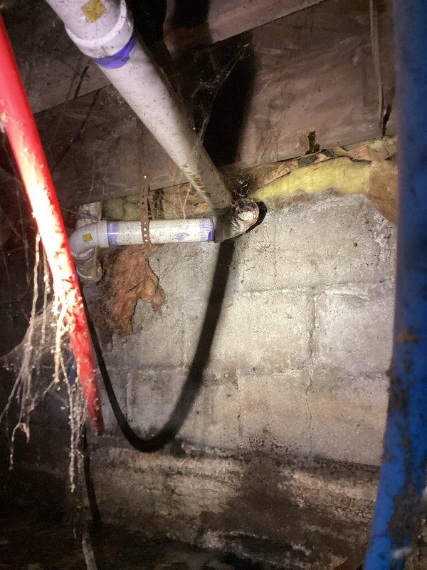 Conducted comprehensive site assessment and documentation for insurance-required drain repipe project estimate in basement crawlspace area. Photographed existing plumbing infrastructure including white PVC drain lines, flexible hoses, and metal pipe fittings showing significant age-related deterioration. Documented concrete block foundation walls exhibiting moisture staining, efflorescence, and mineral deposits indicating historical water seepage. Identified deteriorated piping with visible wear, discoloration, and compromised connections requiring replacement. Captured detailed images of crawlspace conditions including sump area, drainage systems, and structural elements to provide insurance company with additional technical information necessary for claim processing and project scope determination.