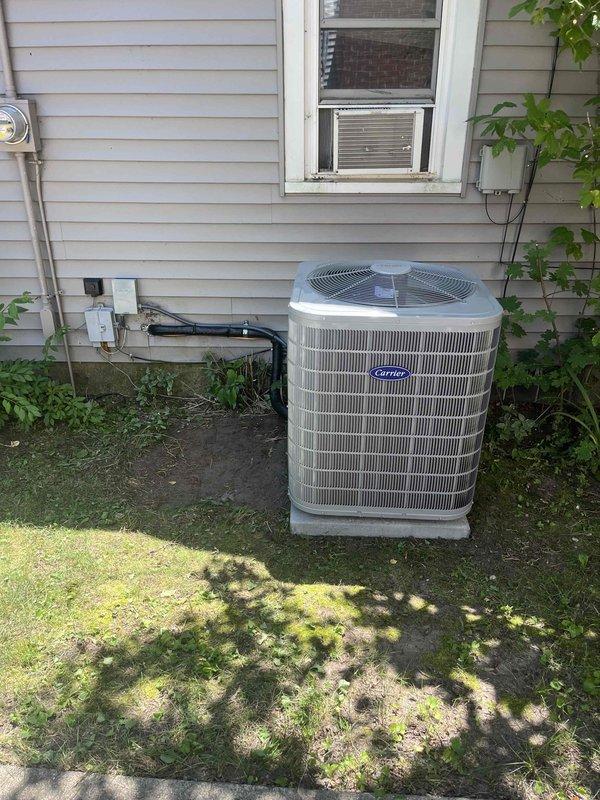 Completed full HVAC system installation including new Carrier outdoor condensing unit and indoor furnace. Positioned condenser on concrete pad adjacent to home exterior with proper clearances, connected refrigerant lines and electrical service through exterior wall penetration. Installed furnace in basement utility area with galvanized supply ductwork and 90-degree elbow configuration for proper airflow distribution. Ran electrical conduit and wiring to both units, ensuring all connections meet code requirements. Verified refrigerant charge, tested system operation across heating and cooling modes, and confirmed proper airflow and temperature differentials at supply registers.