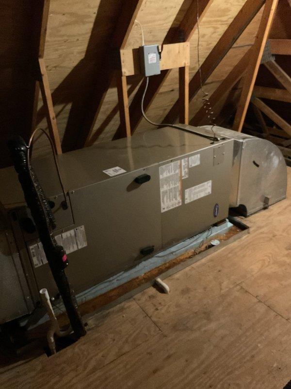 Responded to no cooling complaint on upper level of residence with Carrier system installed September 2020. Accessed attic-mounted air handler using extension ladder through interior hallway access point. Inspected unit and found system operational with no mechanical faults identified; verified airflow, electrical connections, and thermostat communication functioning properly.