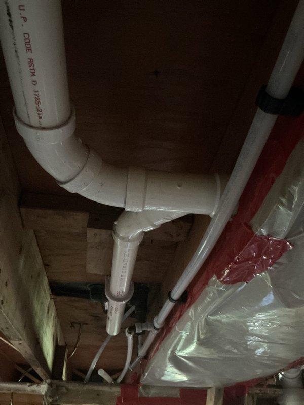 # Upstairs Bathroom Drain and Water Repipe

Completed comprehensive drain and water repipe installation for upstairs bathroom over a three-day period. Installed new PVC drainage system with proper venting configuration, including vertical stack and horizontal drain lines with code-compliant fittings and connections. Replaced existing water supply lines with new piping, securing all components with appropriate mounting brackets and hangers to floor joists. All work performed in accordance with UPC code standards, utilizing ASTM D1785-12 certified materials. System installed in crawl space area, coordinating routing around existing HVAC ductwork and structural framing to ensure proper clearances and accessibility for future maintenance.