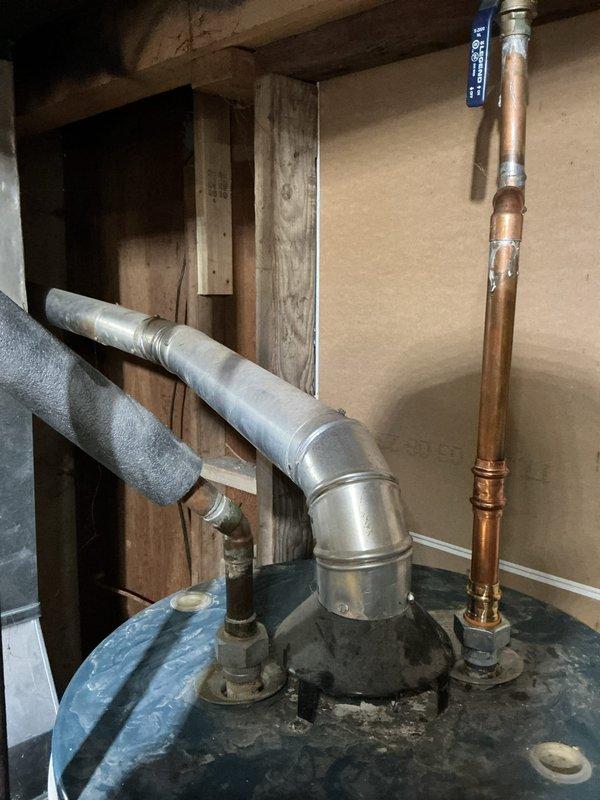 Responded to no cooling complaint on 2-year-old Payne air conditioning system. Upon arrival, discovered images documented water heater and plumbing components in mechanical space rather than AC equipment. Unable to diagnose or service air conditioning unit as AC system was not accessible or photographed during this visit.