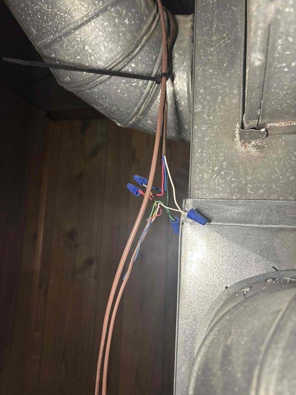 Responded to no cooling call on 13-year-old system with outdoor unit not operating. Upon arrival, inspected thermostat wiring and connections at wall-mounted unit, verifying proper wire terminations at designated terminals (R, RC, G, Y, W, O/B). Examined attic space where HVAC ductwork and electrical wiring are located, checking wire connections secured with wire nuts and cable ties along main trunk line. Confirmed all electrical connections were properly secured and junction points were intact. Troubleshot system operation and restored cooling functionality to unit.