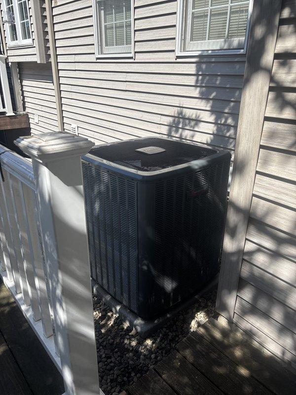 Completed full air conditioning system replacement at residential property. Installed new condensing unit on existing raised gravel platform with terraced retaining wall structure, ensuring proper elevation and drainage. Unit positioned against exterior siding with appropriate clearances maintained for airflow and serviceability. All electrical connections completed per manufacturer specifications and local code requirements. System tested and verified operational with proper refrigerant charge and airflow. Customer instructed on new system operation and maintenance requirements.