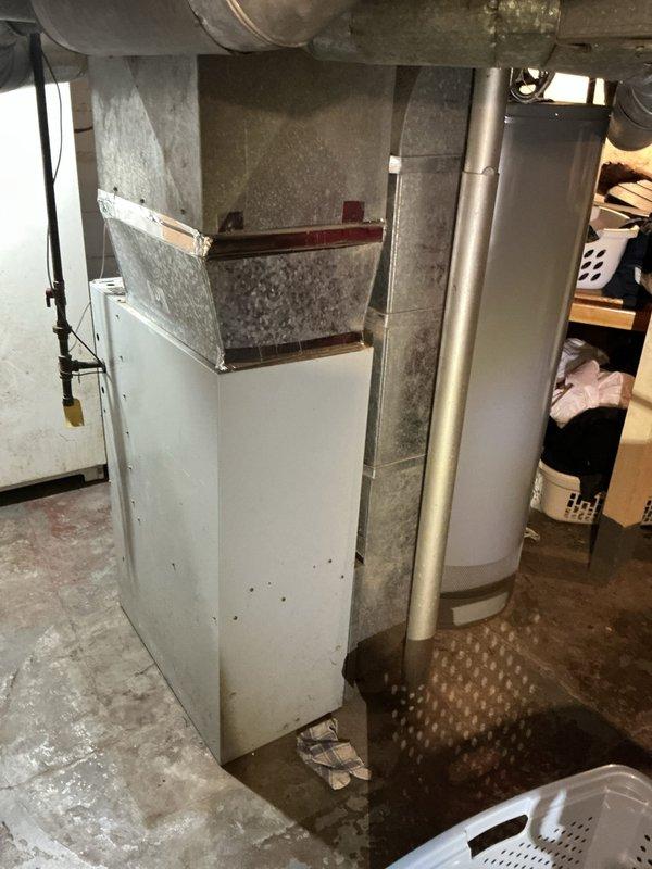 Responded to service call for air conditioning system not cooling properly with mild cooling still present. Upon inspection, identified refrigerant leak at outdoor condensing unit. Evaluated both outdoor condensing unit and indoor air handler system, documented equipment condition with overgrown vegetation surrounding outdoor unit requiring clearance for proper airflow and maintenance access. Provided estimate for refrigerant leak repair and system restoration.