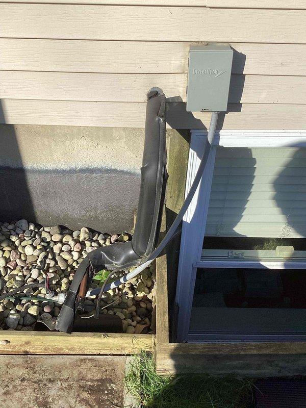 # Condenser Removal - Customer Waiting on Warranty

Documented existing outdoor air conditioning condenser unit for scheduled removal under warranty claim. Unit showed significant aging and environmental wear with faded cabinet finish, surface discoloration, and weathered components. Photographed condenser positioned on concrete pad with visible moss growth and staining. Documented refrigerant line connections and electrical service installation including weatherproof disconnect box mounted on metal conduit stand near basement window well. Return visit scheduled to complete condenser removal per warranty authorization.