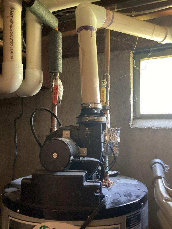 Completed water heater tune-up service on AO Smith gas water heater installed in utility closet of 72-year-old residential home. Performed complete tank flush to remove sediment buildup, inspected all plumbing connections and supply lines for signs of corrosion or rust concerns noted by homeowner, verified proper venting operation, and tested TPR valve functionality. All components found operating within normal parameters with no immediate safety concerns identified.